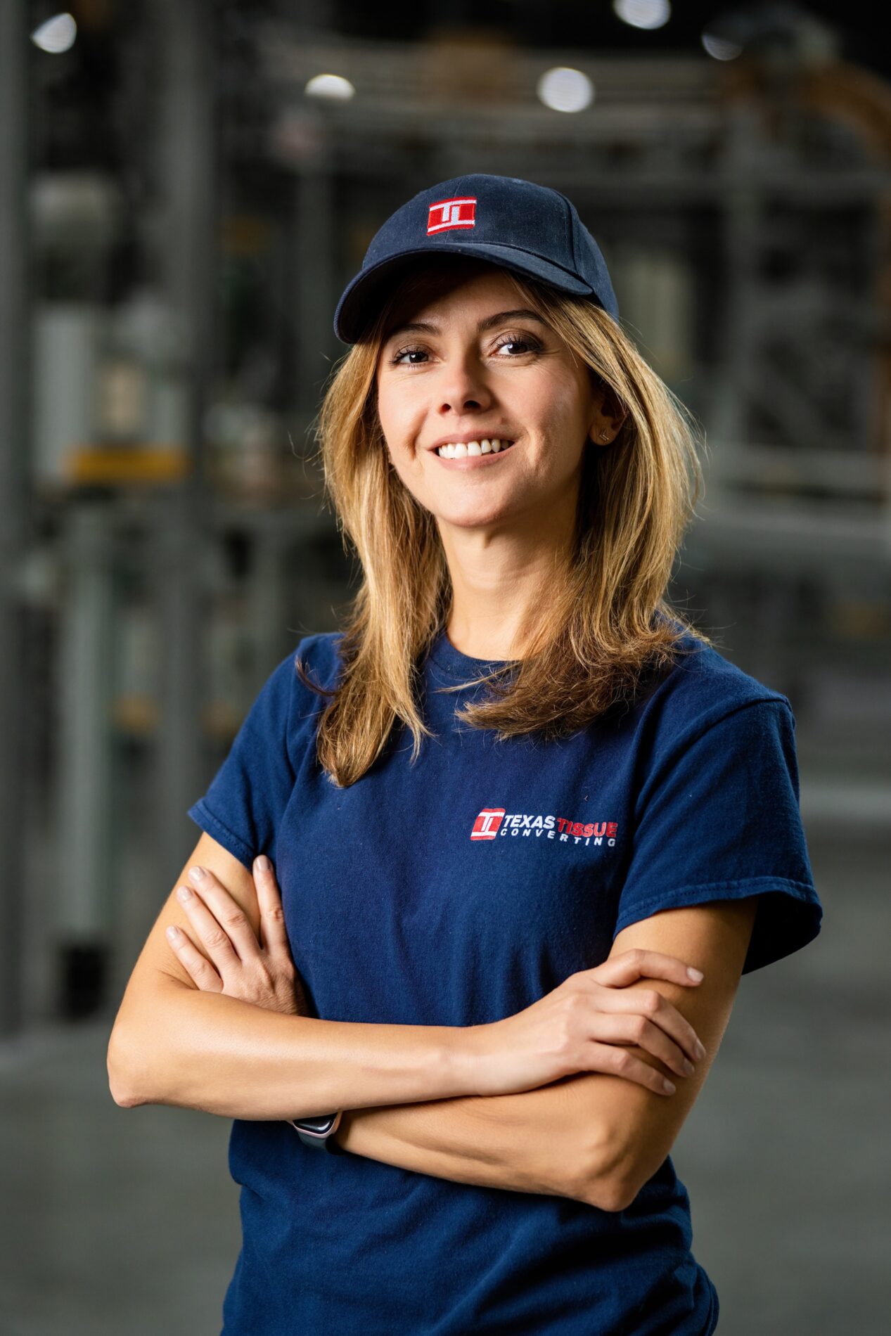 Portrait of a Texas Tissue employee in a company cap and shirt