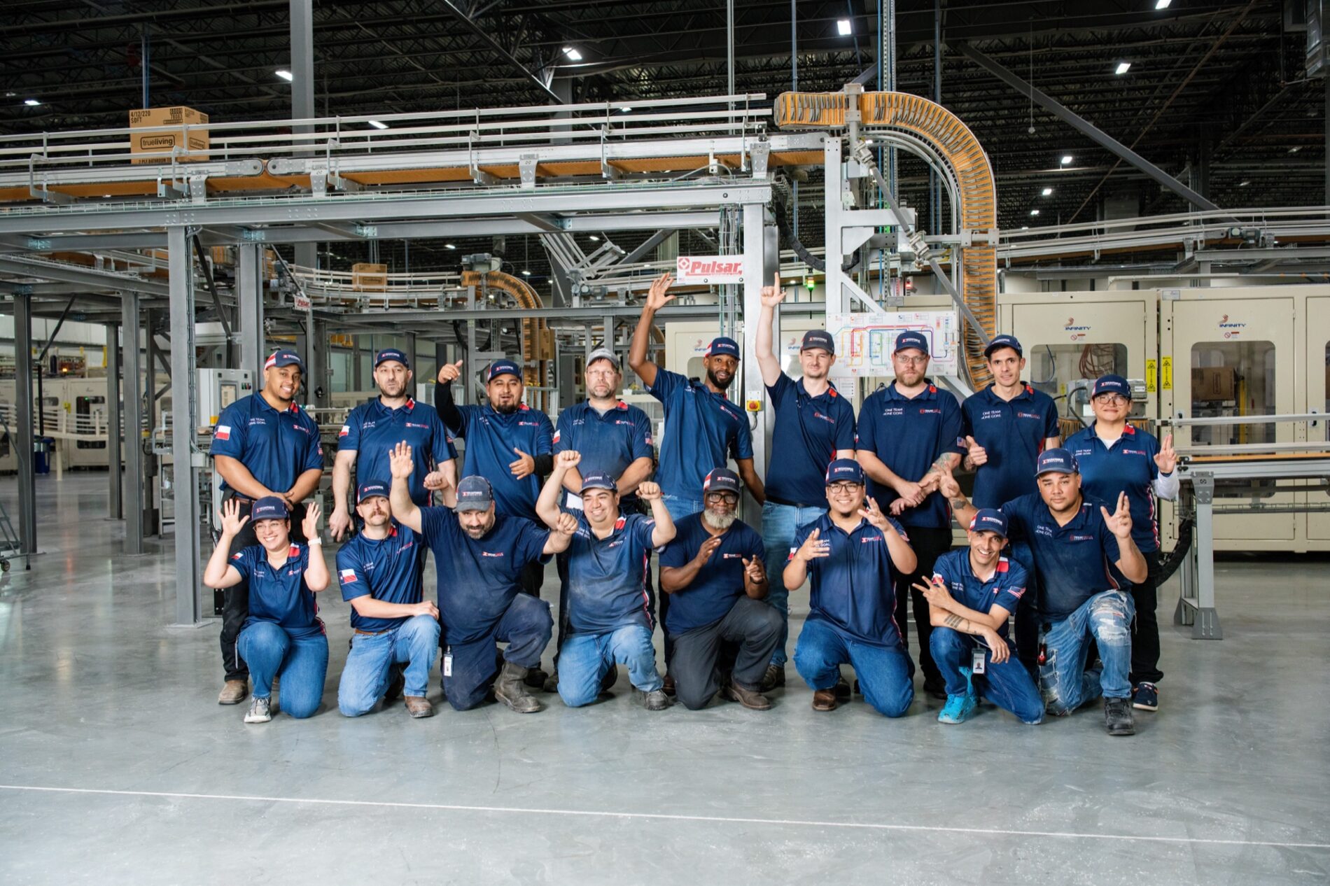 Texas Tissue employees posing together in the manufacturing facility