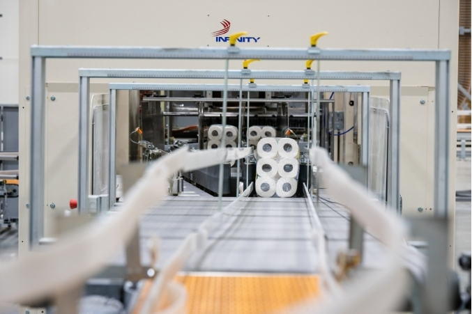 Packaged bath tissue moving along the production line